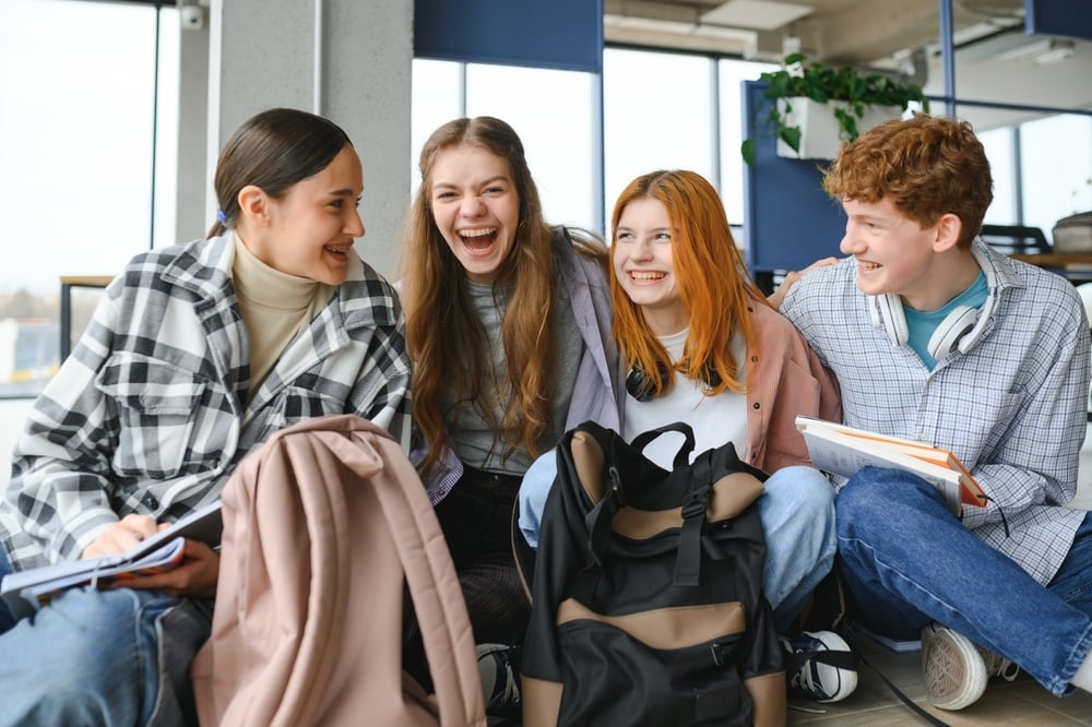 gruppo di ragazze seduti che sorridono tra di loro